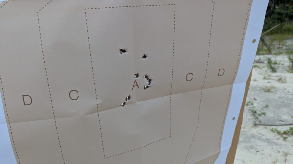 USPSA paper target with several holes in the A zone
