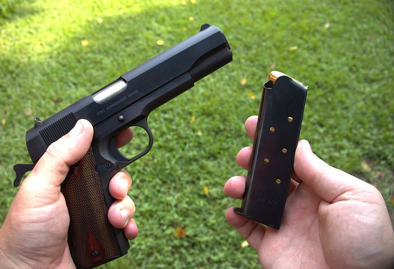 colt 1911 45 acp pistol and loaded magazine