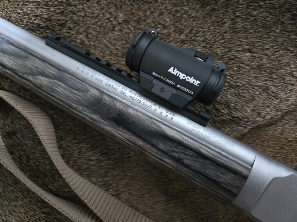 Aimpoint red dot sight mounted to a barrel picatinny rail