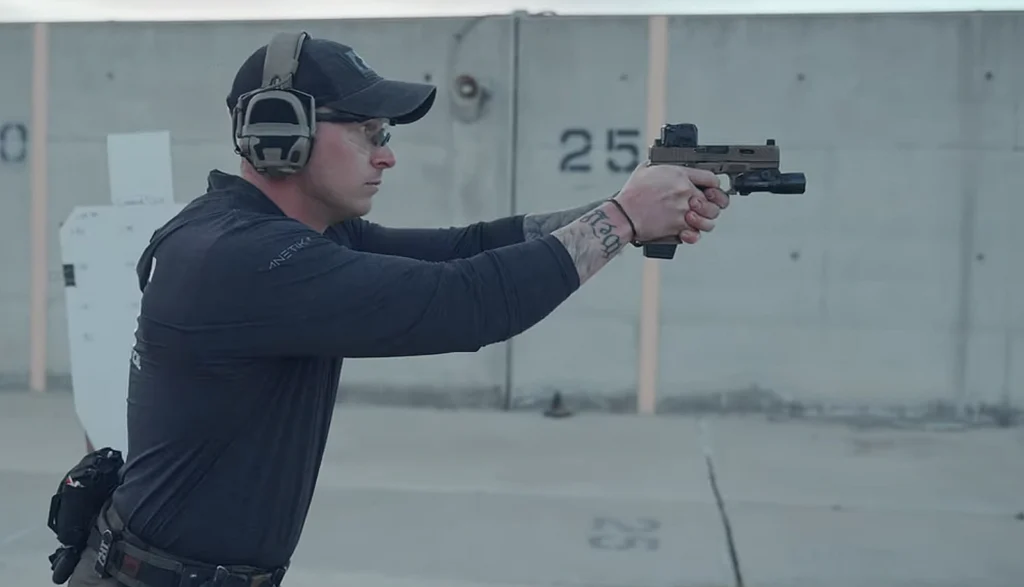 Man firing a semi-automatic pistol on a shooting range