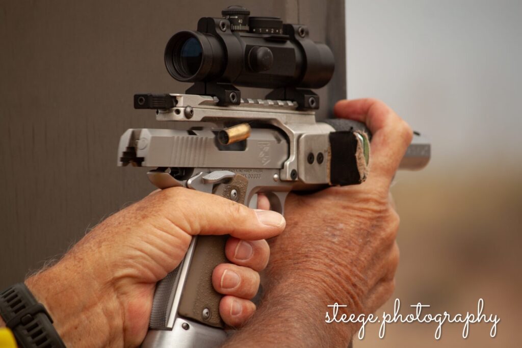 Open gun shooting off a barricade.