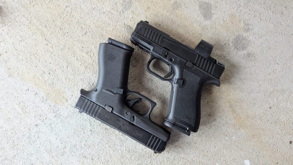 A comparison shot of two pistols, a PSA Micro Dagger and a Glock 43X, lying next to each other on a concrete surface.