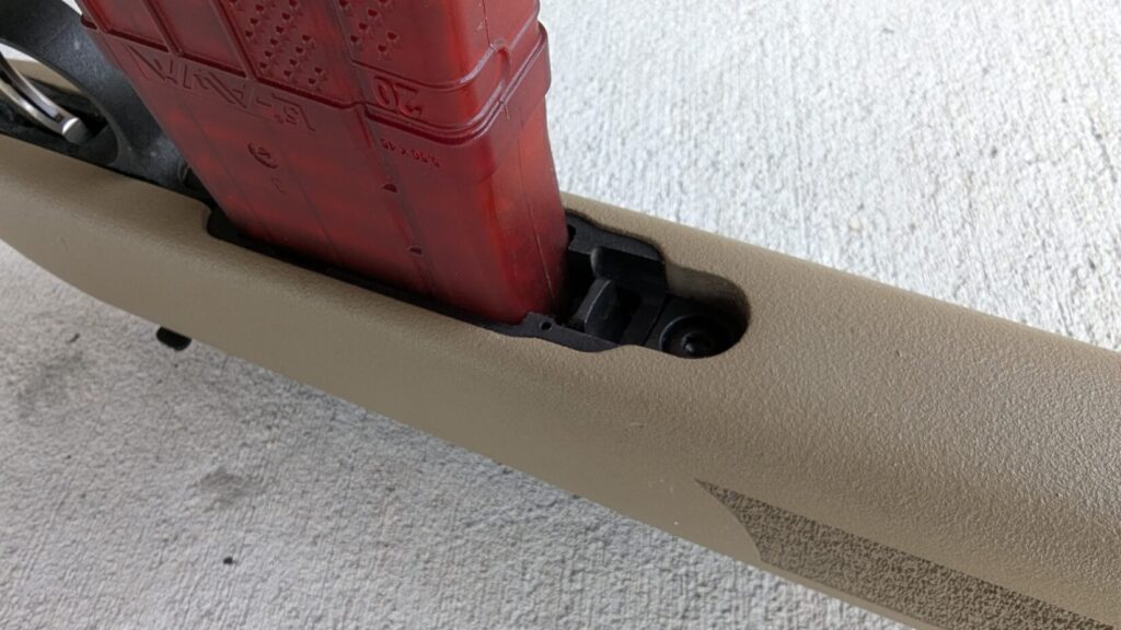 A close-up of the Mossberg MVP Patrol magazine release