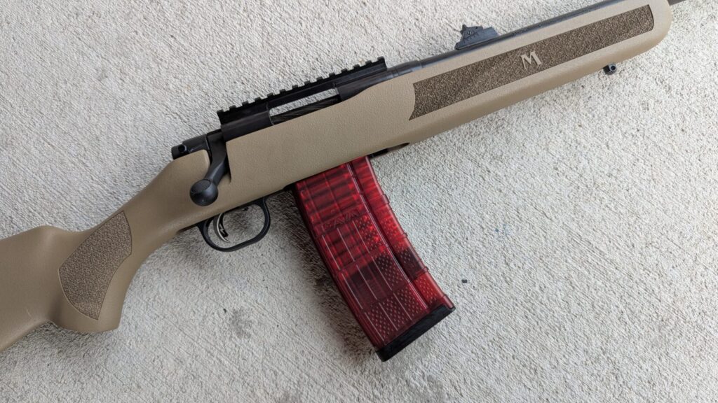 Mossberg MVP Patrol rifle with red magazine on concrete.
