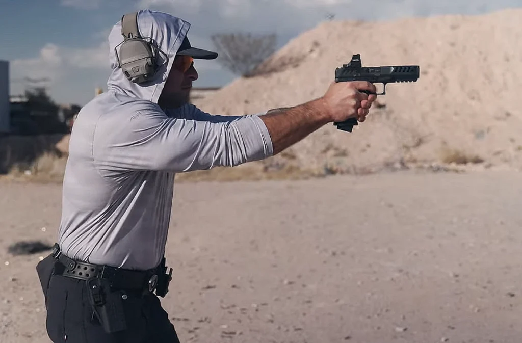 Man firing a semi-automatic pistol on a shooting range