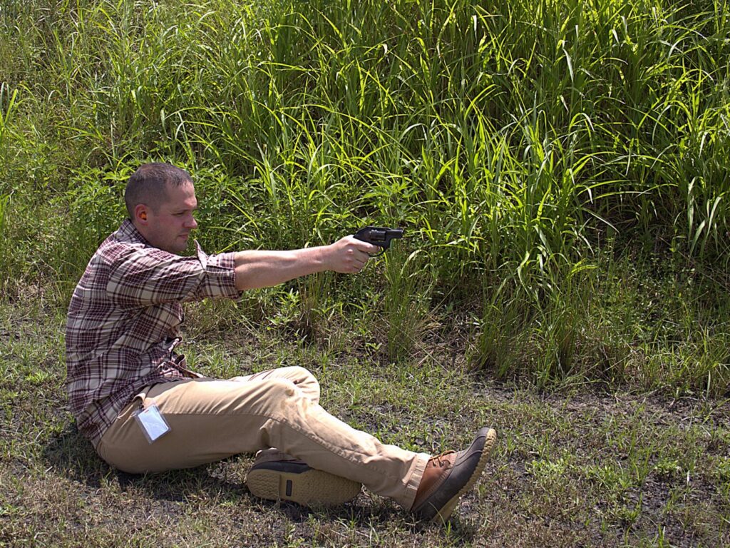man shooting the ruger lcr 9mm from a sitting position