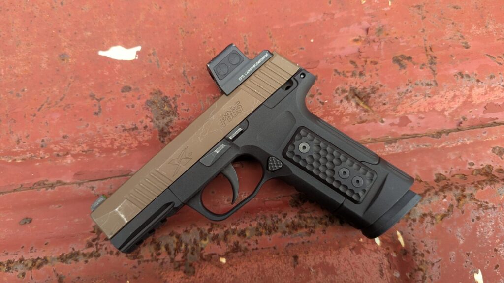 P365 with Macro S365 grip and optic on red surface.