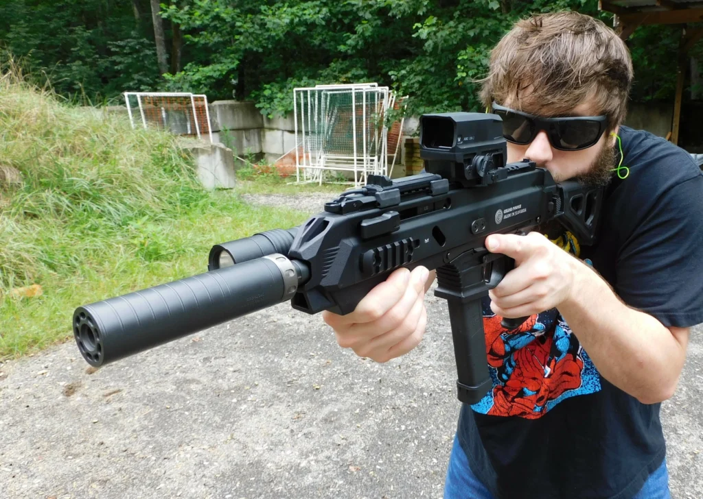 Man firing a suppressed Stribog pistol with SilencerCo Spectre 9