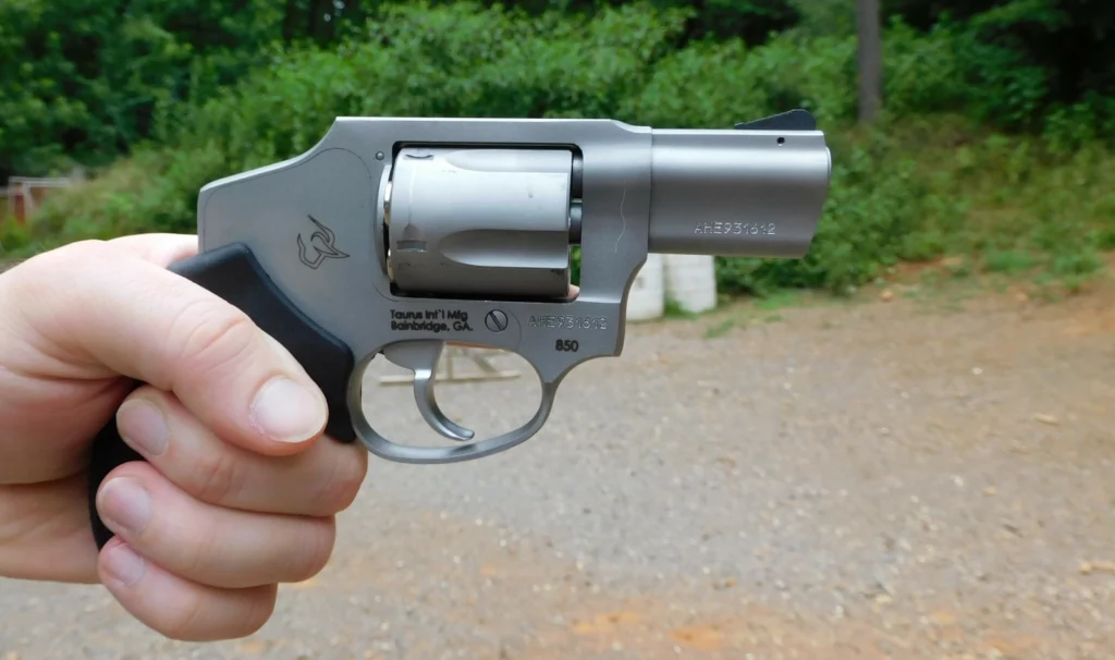 Taurus 850 revolver, right profile, in hand, outdoors