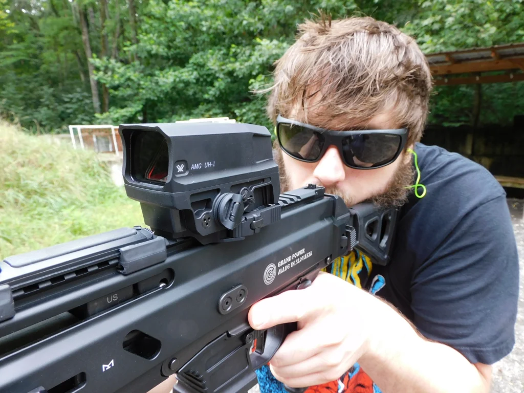 Man firing a Stribog pistol equipped with a Vortex UH-1 holographic sight