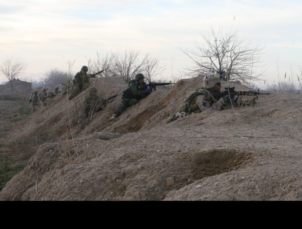 U.S. Marines with Bravo Company, 1st Battalion, 6th Marine Regiment return fire on enemy forces in Marjeh, Afghanistan, on 22 February 2010. Marines are securing the city of Marjeh from the Taliban. (U.S. Marine Corps photo by Lance Cpl Andres J. Lugo. Public Domain)