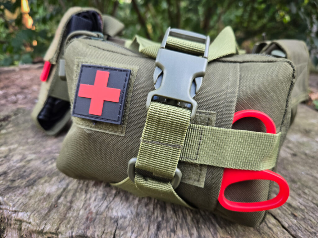 tactical medical kit mounted on a green belt