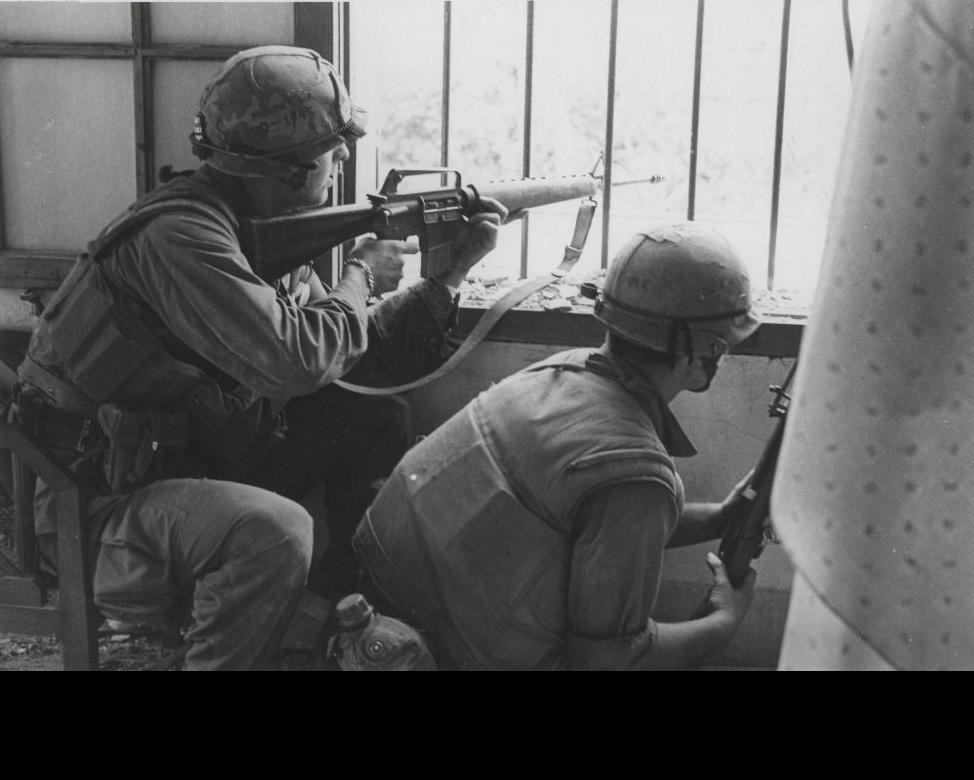 1st Battalion, 1st Marines [A/1/1] fire from a house window during a search and clear mission in the battle of Hue. (U.S. Marine Corps photo by Sergeant Bruce A. Atwell from the Jonathan Abel Collection (COLL/3611), Marine Corps Archives & Special Collections. CC BY-SA 2.0)