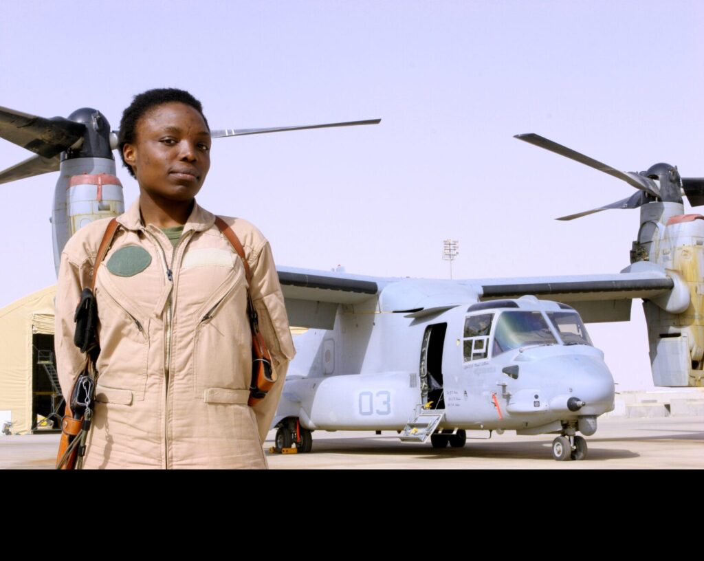 Captain Elizabeth A. Okoreeh-Baah, the first female MV-22 Osprey pilot, stands on the flight line in Al Asad, Iraq, after a combat operation on March 12, 2008. (U.S. Marine Corps photo by Cpl. Jessica Aranda. Public Domain)