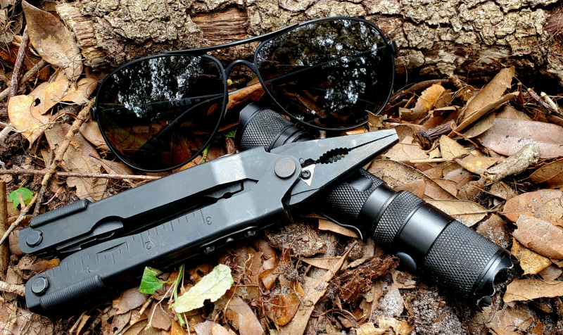 EDC components: multitool, flashlight, and sunglasses