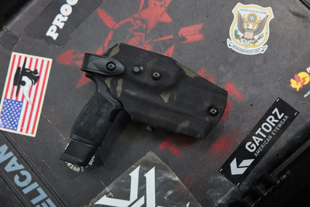 An overhead view of a black camouflage Safariland 6360RDS holster, shown with a SIG P365 XMACRO handgun