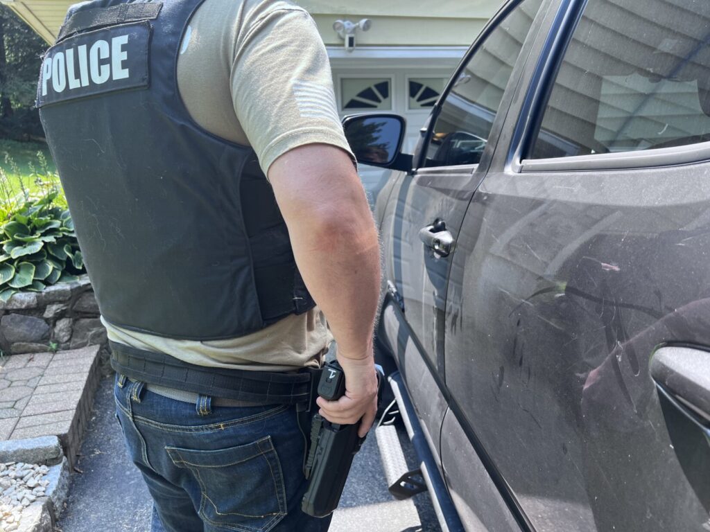 Officer with hand on gun during traffic stop