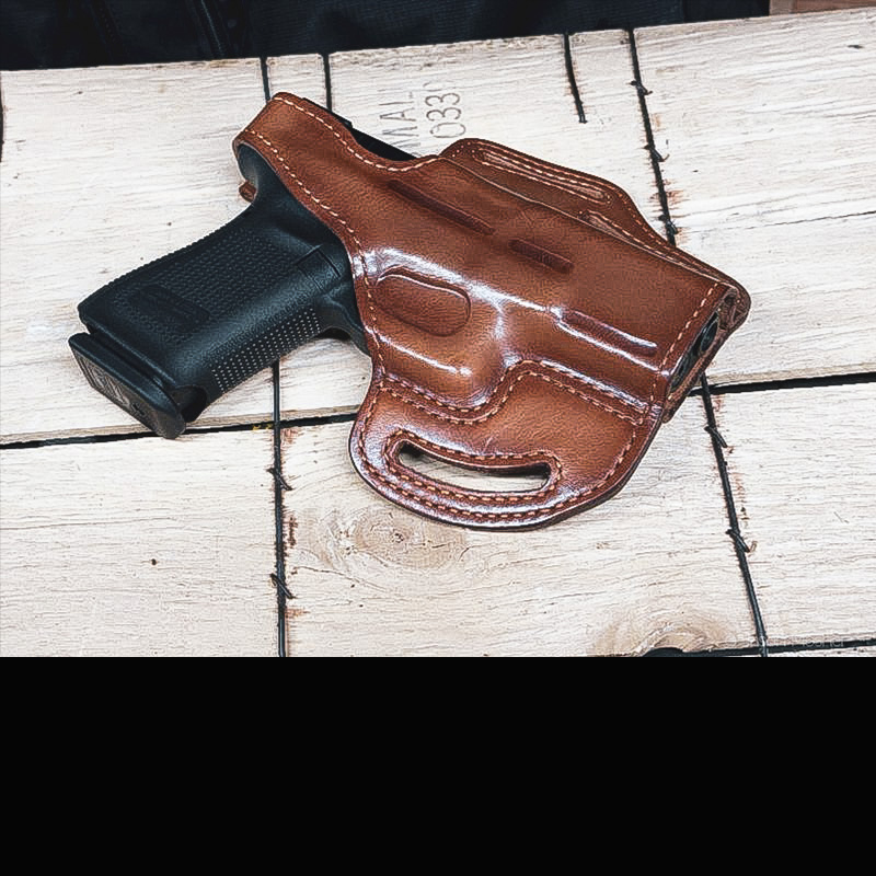 Bianchi leather holster with a Glock 19 in it, laying on a wood box. 