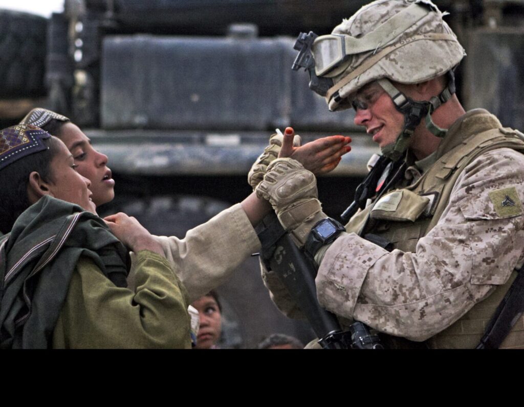 A U.S. Marine interacting with Afghan children in Helmand Province. (U.S. Marine Corps photo by Lance Cpl. Jessica S. Gonzalez, Public Domain)