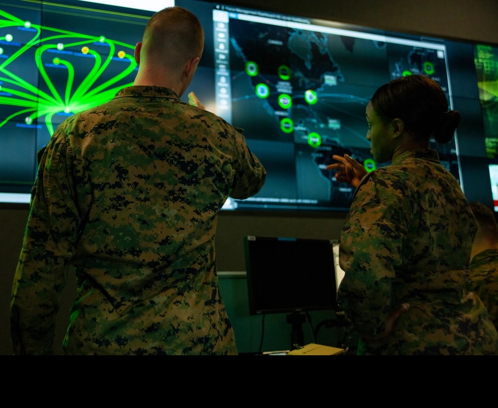 Marines with Marine Corps Forces Cyberspace Command pose for photos in the cyber operations center at Lasswell Hall aboard Fort Meade, Maryland, Feb. 5, 2020. This image is a photo illustration. (U.S. Marine Corps photo by Maj. Zachary Leuthardt. Public Domain).