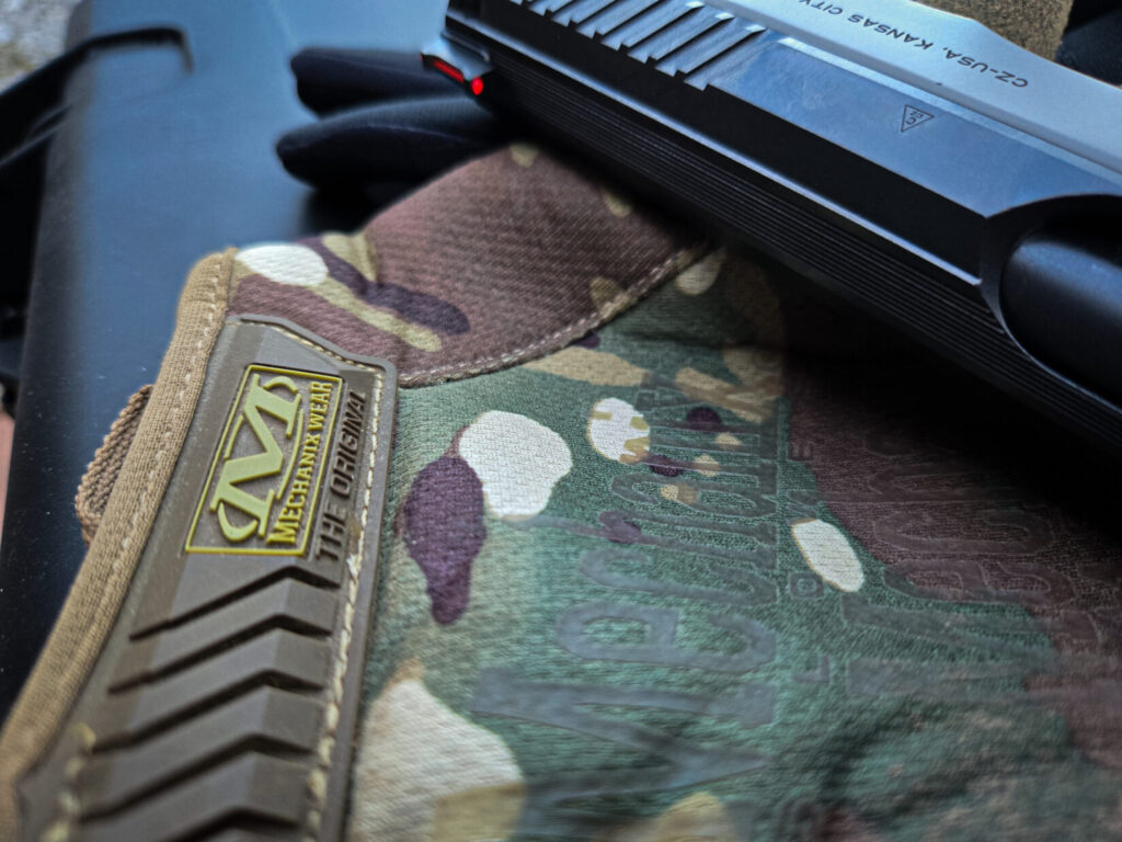 Mechanixwear gloves with a handgun in the background