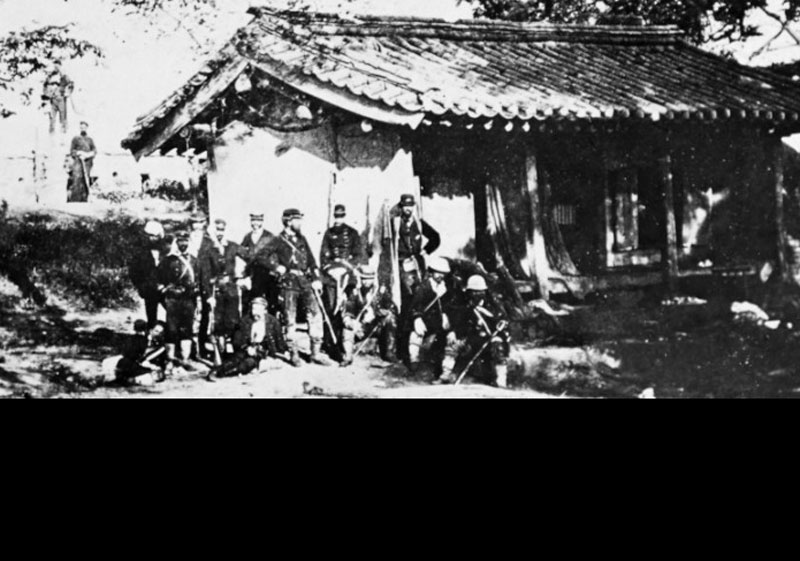Group of officers of the landing party, by a captured Korean building, June 1871. (Image: Public Domain/Naval History and Heritage Command)