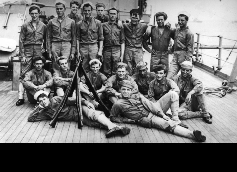 A group of U.S. Navy sailors, who would have been deployed as infantry, possibly from the battleship USS South Carolina (BB-26). They are wearing USMC flannel shirts and khaki trousers but can be identified as sailors with their dyed white hats. (Public Domain/Courtesy of Carter Rila, 1986. U.S. Naval History and Heritage Command Photograph)