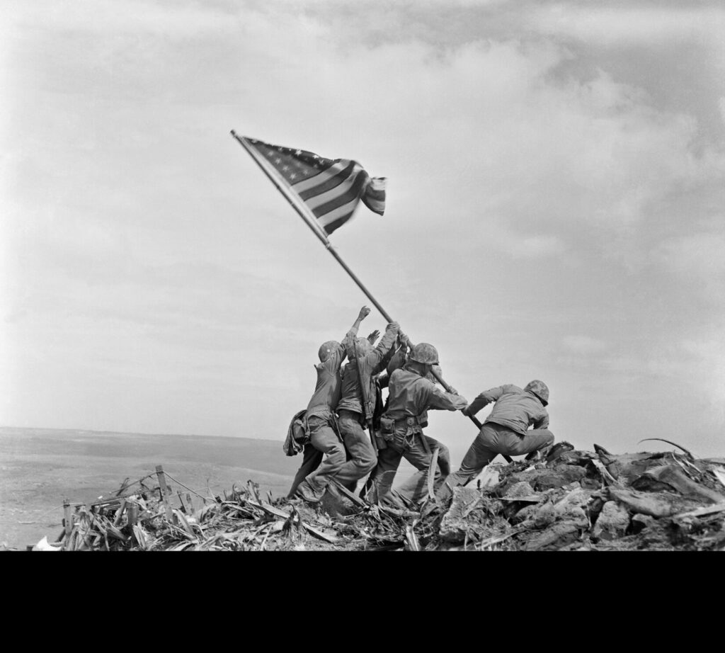 The famous photograph oF MARINES Raising the AMERICAN Flag on Iwo Jima by Joe Rosenthal of the Associated Press. (Public Domain)