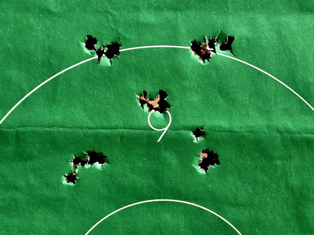 five shot groups on a green target
