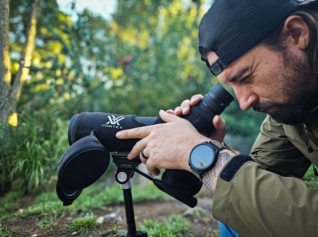 man with spotting scope