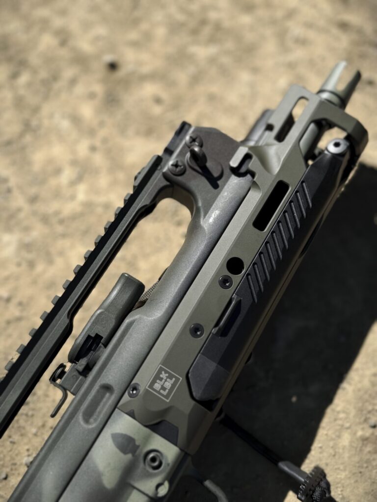 A closeup side profile view of the Blk Lbl Hellion forend installed on the rifle.