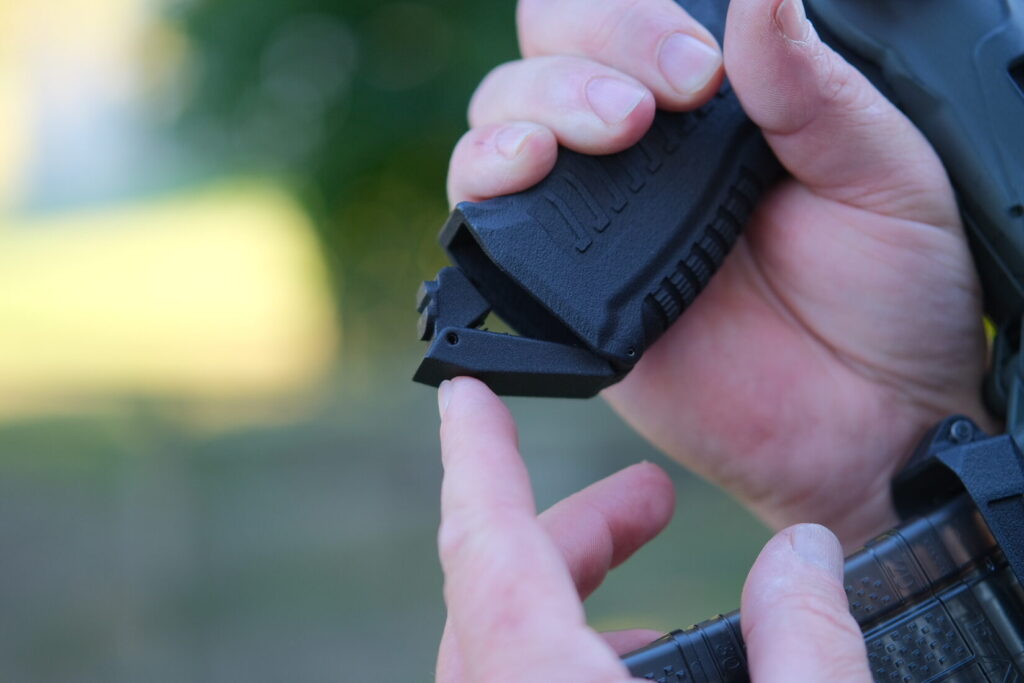 closeup view of the hinged trap door on the Lunartech Designs Pistol Grip