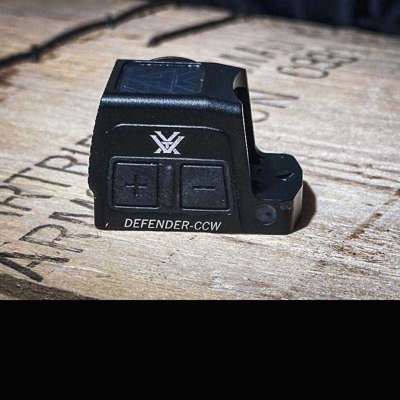 Vortex Defender CCW on a wood box. The view is of the side, showing the large control buttons. 
