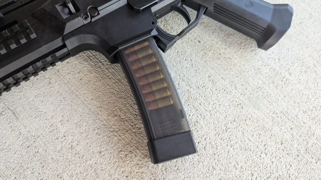 A close-up view of the loaded, translucent magazine on a CZ Scorpion Evo 3 pistol.