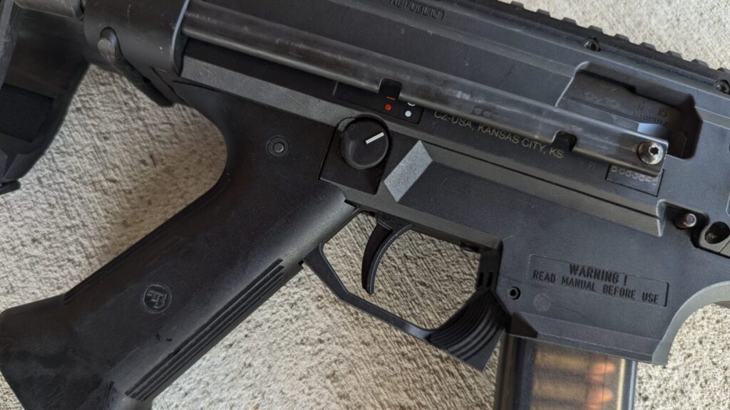  A close-up of the trigger and grip area of a CZ Scorpion Evo 3 pistol.