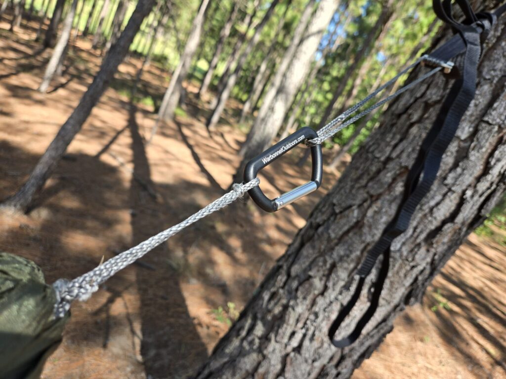 A hammock suspension system including small carabiners, dyneema cordage, and titanium hardware.
