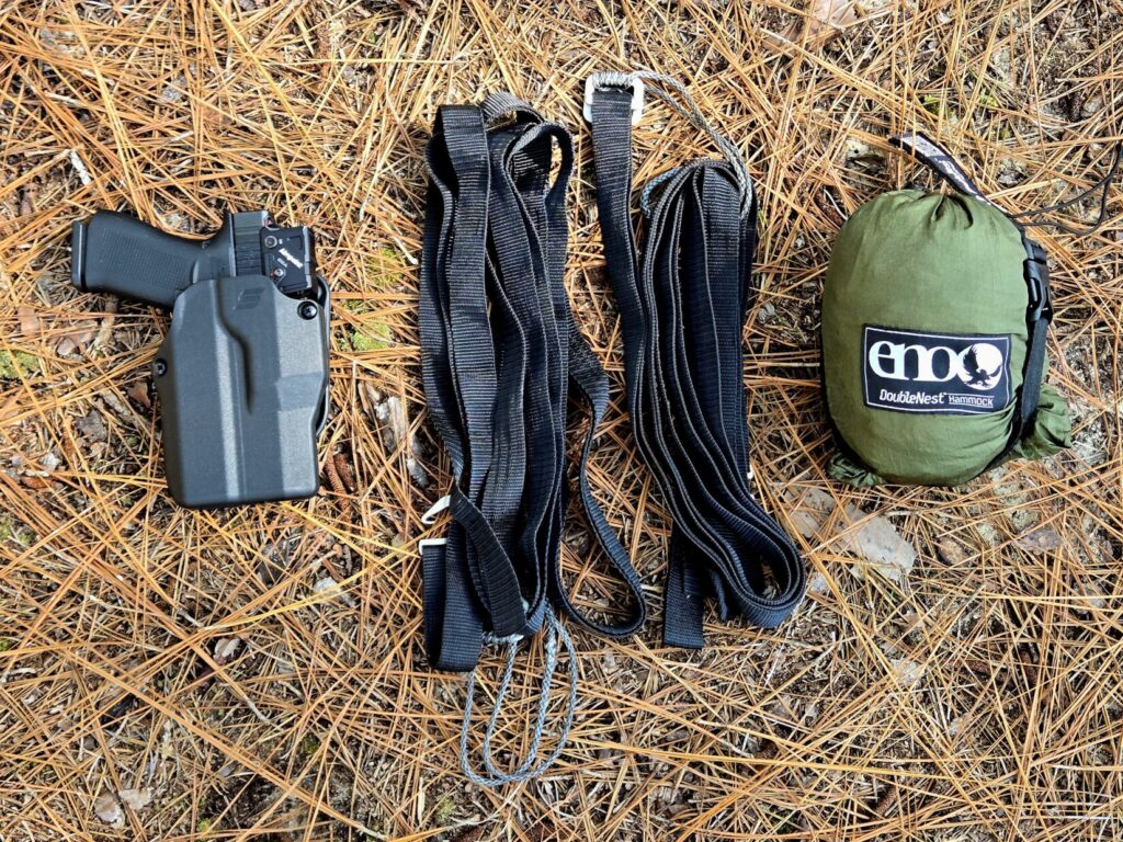 A glock 43 COA pistol in a safariland holster, suspension straps and hammock in a stuff sack.