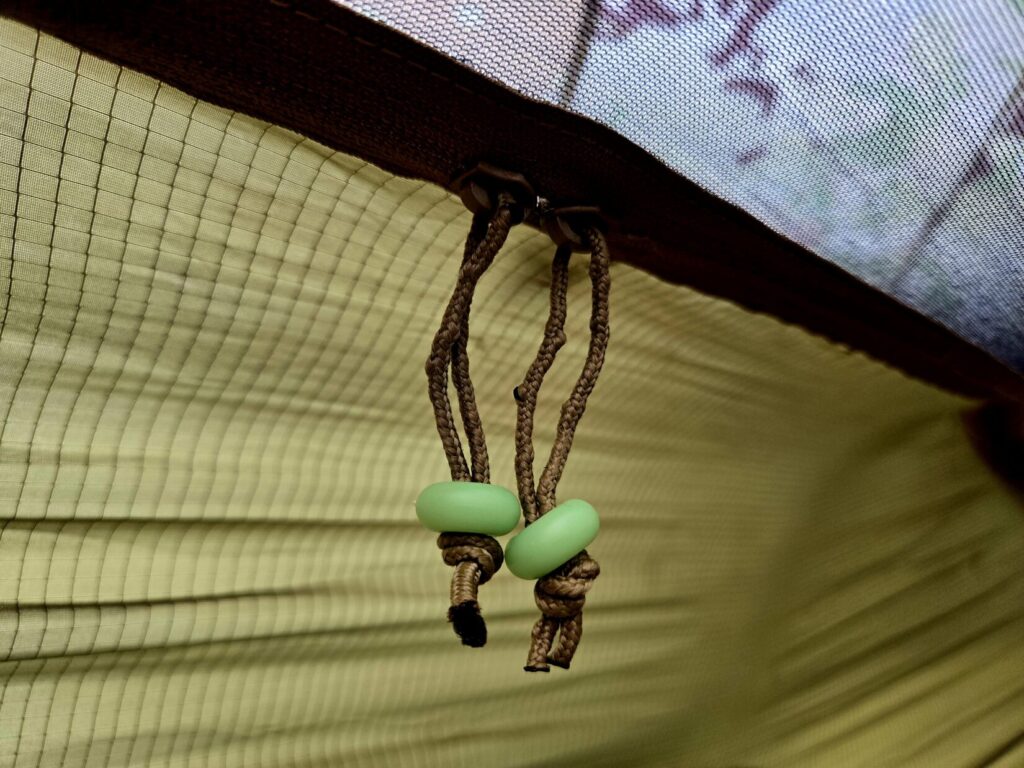 Zipper pulls with glow in the dark beads and mosquito netting.