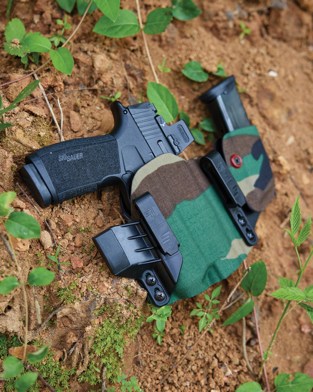 Sig Sauer P365 in Safariland Incog X holster with M81 woodland camo wrap, highlighting modern gear in classic camo.