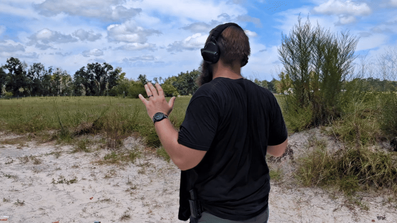Man turning, drawing, and shooting handgun