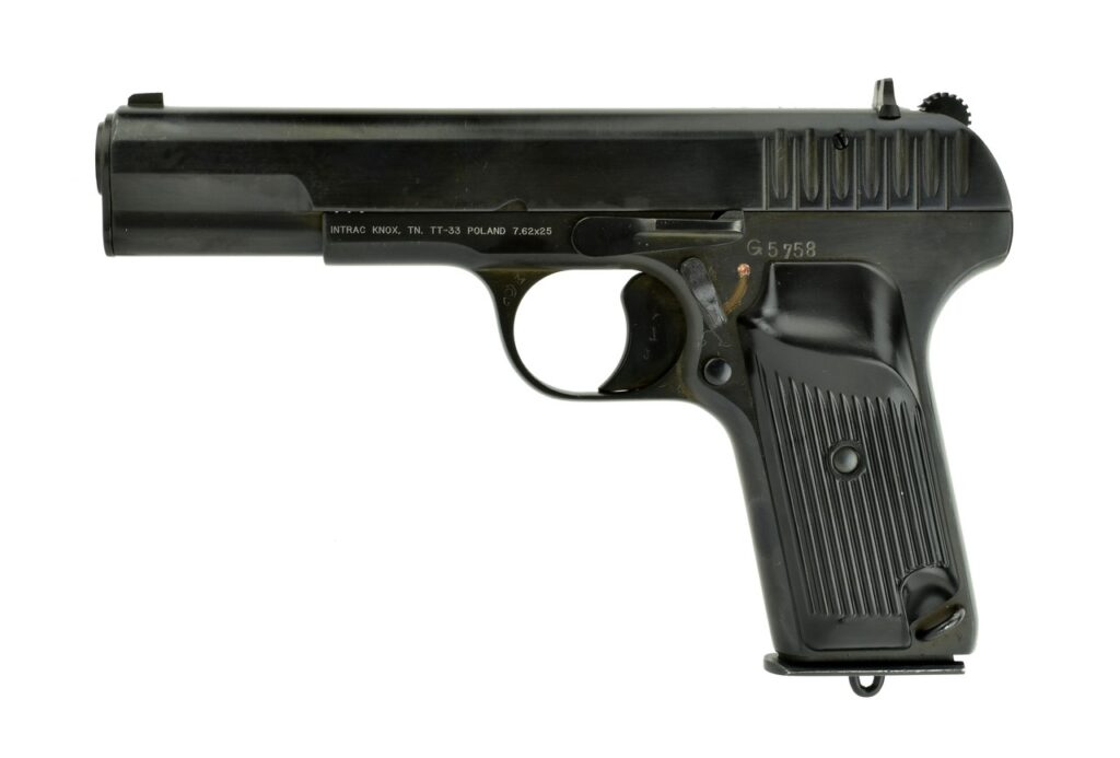 A dark-colored Tokarev TT-33 pistol is shown against a white background. The slide has vertical serrations at the back, and the grip is ribbed.
