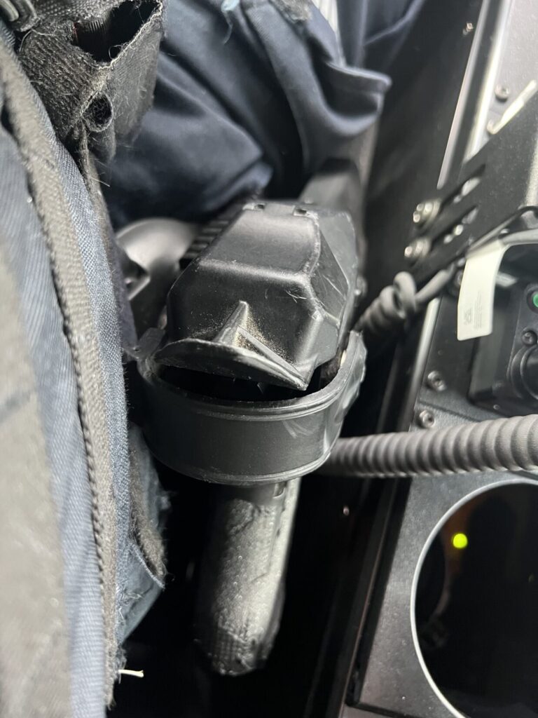 outer vest carrier blocks access to holster retention
