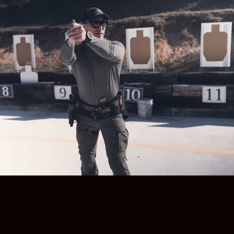 Safariland CADRE Rick Crawley standing on the range, demonstrating how to hold a gun to students. 