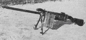 black and white historical photo of a heavy machine gun,