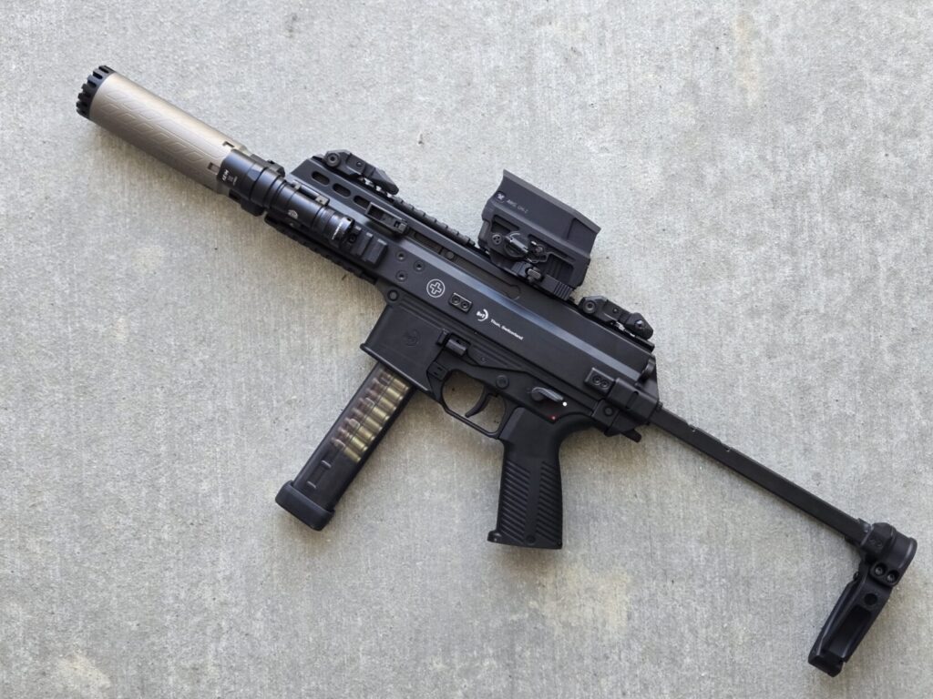 B&T APC9 pistol with suppressor, surefire light, vortex optic, and gear head works brace.