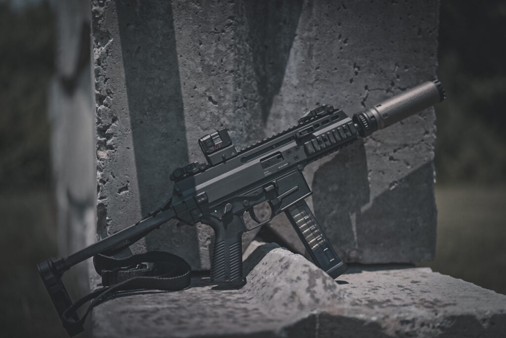 A firearm sitting on top of a concrete barricade