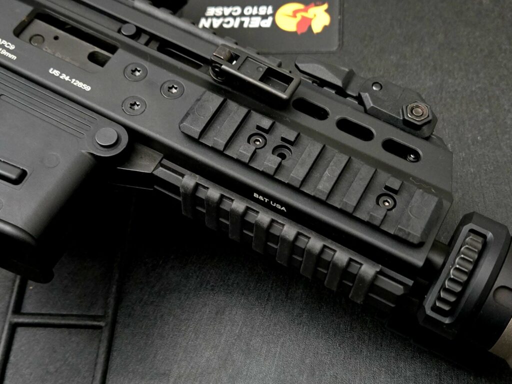 The picatinny rail and back up iron sight from a B&T APC9 Pro on top of a Pelican Case