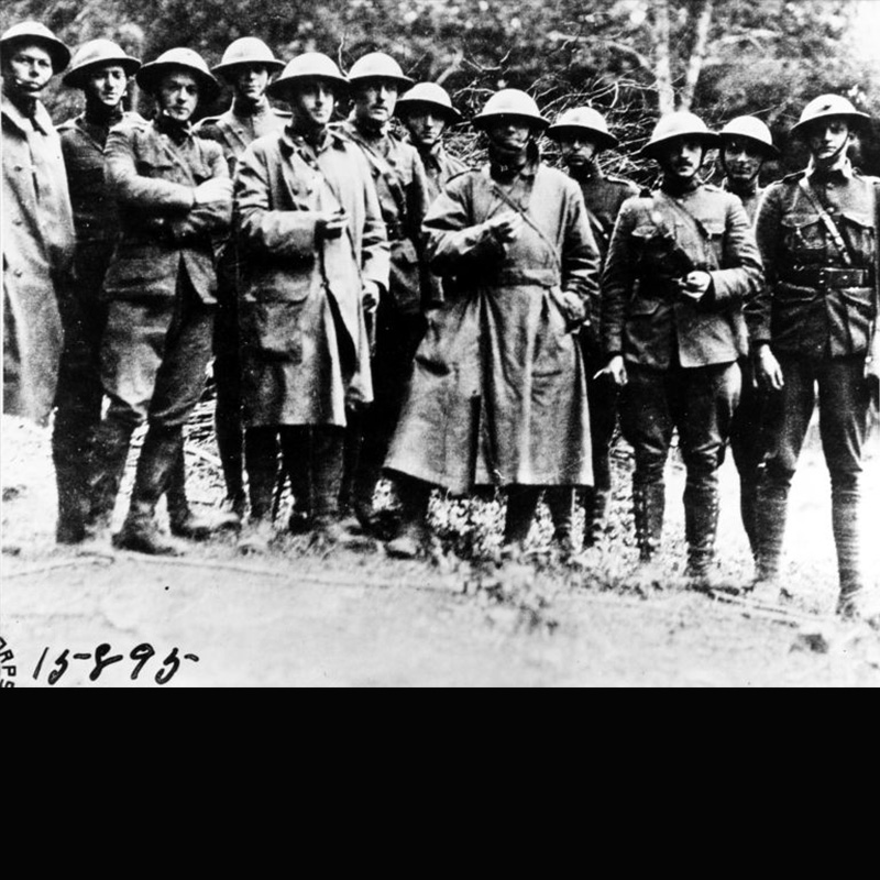 black and white photo showing a small group of marines in in dirty clothes just after the battle of Belleau Wood.