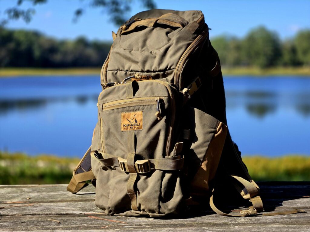 A ranger green kifaru shape charge backpack with sherman pocket