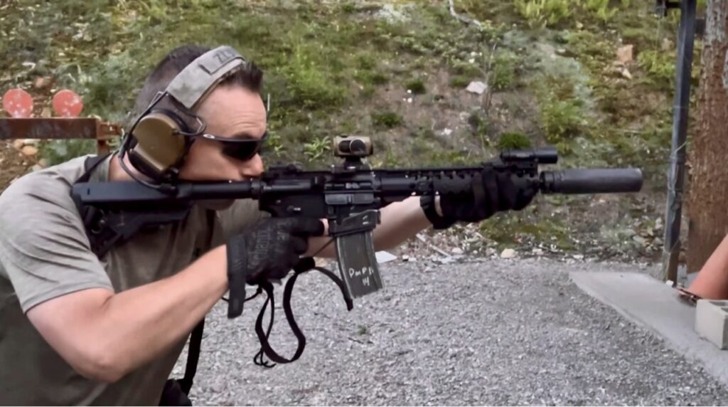 man shooting Colt Commando